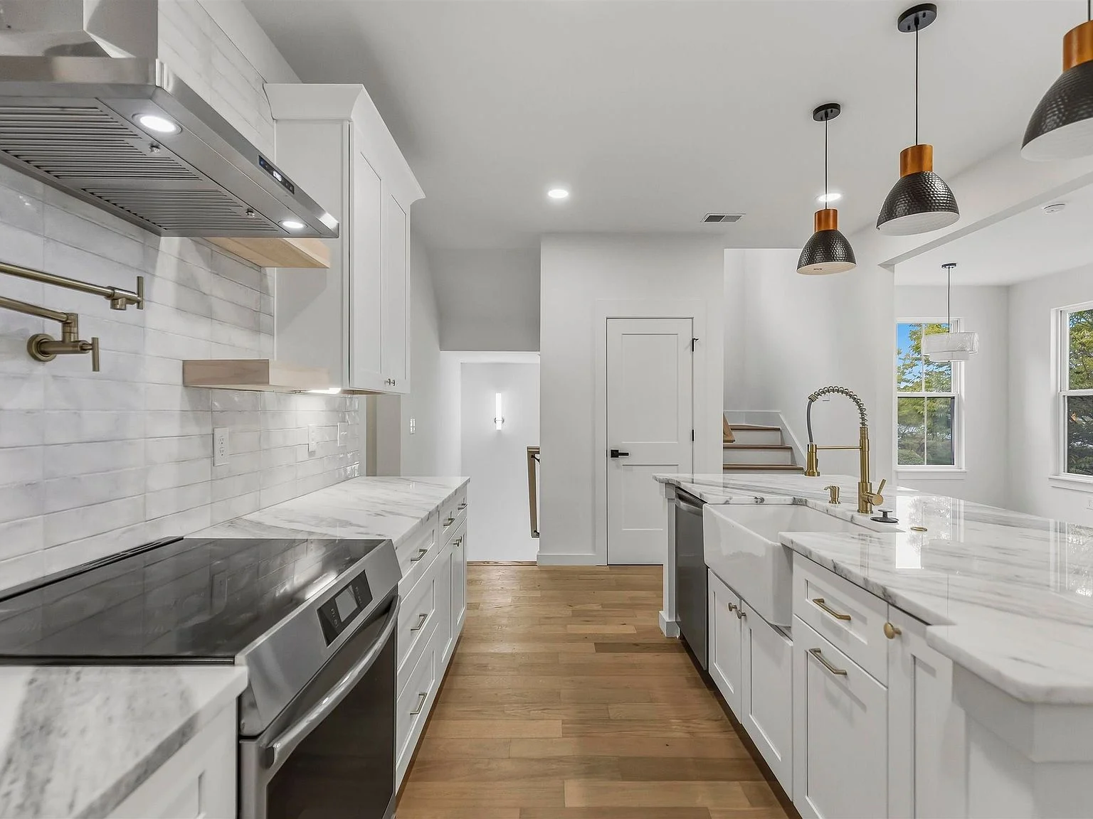 Kitchen cabinetry, range, and farmhouse sink