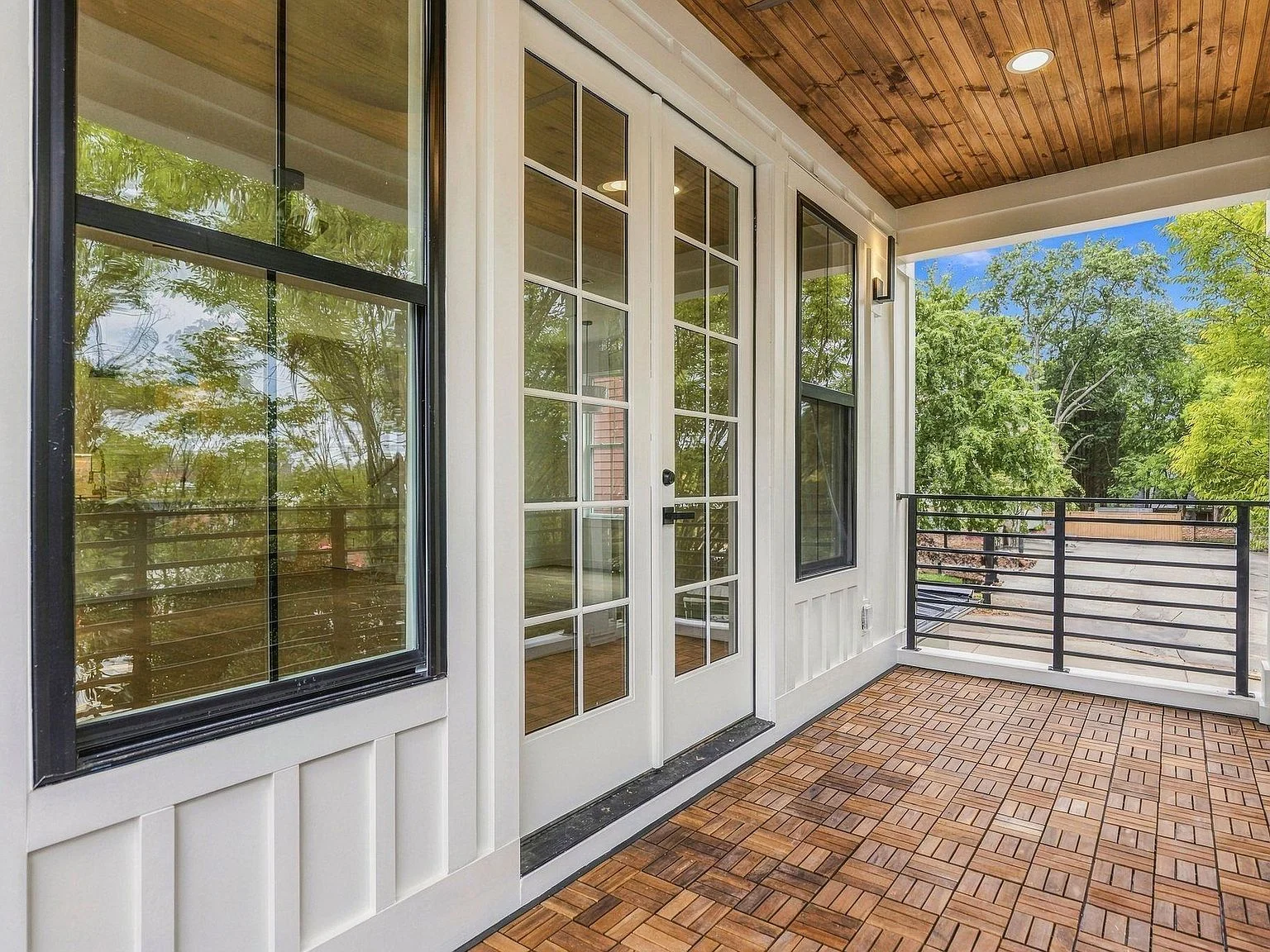 Covered second-level porch with wood ceiling