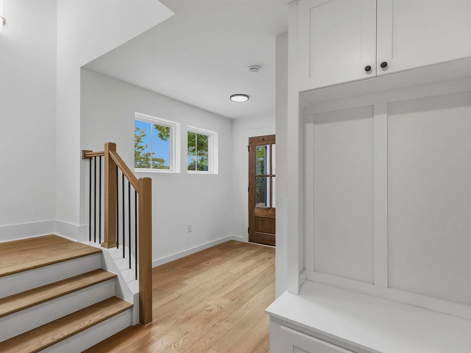 Staircase and entry hall connecting the home’s three levels